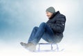 Cool bearded man on a sled in the snow Royalty Free Stock Photo