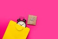 Cool black alarm clock in beautiful yellow shopping bag and cute Royalty Free Stock Photo