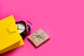 Cool black alarm clock in beautiful yellow shopping bag and cute Royalty Free Stock Photo