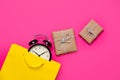 Cool black alarm clock in beautiful yellow shopping bag and cute Royalty Free Stock Photo