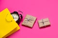 Cool black alarm clock in beautiful yellow shopping bag and cute Royalty Free Stock Photo