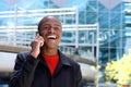 Cool black guy laughing with mobile phone Royalty Free Stock Photo