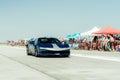 Cool blue car and a group of people at a Drag Racing event at the Arad International Airport