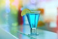 Cool blue cocktail deliciousness. a blue cocktail on a table in a nightclub. Royalty Free Stock Photo