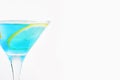 Cool blue cocktail in a glass with ice and a slice of lemon. Refreshing summer alcoholic and non-alcoholic drinks. Copy space Royalty Free Stock Photo