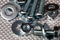 cool blue toned macro of small bolts with nuts and washers on an industrial steel surface. Strong Contrast Royalty Free Stock Photo