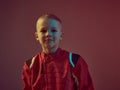 Cool boy child racer in racing suit, standing in neon light. Kart racing school poster. Competition announcement