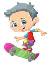 The cool boy is playing a skateboard and showing some trick Royalty Free Stock Photo