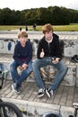 Cool boys sitting on a stone