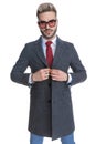 Cool businessman closing his coat, wearing sunglasses Royalty Free Stock Photo