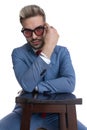 Cool businessman fixing his sunglasses, resting his arms Royalty Free Stock Photo