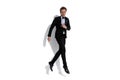 Cool businessman jumping while pointing down Royalty Free Stock Photo