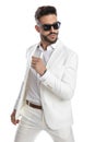 Cool businessman wearing sunglasses and posing with attitude