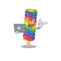 Cool character of rainbow ice cream working with laptop