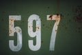 Cool closeup look of white numbers on a rusty old green metal - a good background and wallpaper Royalty Free Stock Photo