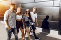 Cool college students in the background of the supermarket, Group of stylish friends, girls and guys walk together on in the city