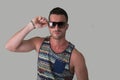 Cool confident young man with sunglasses and tank-top