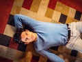 Cool dark-haired handsome young man laying on the floor Royalty Free Stock Photo