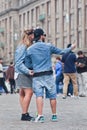 Cool dressed couple takes selfie on Dam Square, Amsterdam, Netherlands