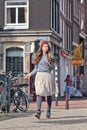 Cool dressed girl walking on the street, Amsterdam, netherlands