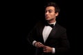 Cool elegant young man in tuxedo unbuttoning his coat Royalty Free Stock Photo