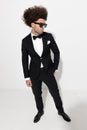 cool fashion businessman in tuxedo holding hands in pockets and looking to side Royalty Free Stock Photo