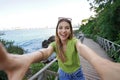 Cool fashion laughing girl takes self portrait in Balneario Camboriu, Brazil. Selfie of young stylish model on pathway seafront of Royalty Free Stock Photo