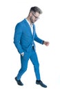 Cool fashion man in blue suit holding hand in pocket and posing Royalty Free Stock Photo