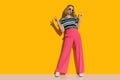 Cool fashion model in pink loose pants and sunglasses is showing peace hand sign Royalty Free Stock Photo