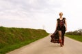 Cool fashionable woman walking wearing dress and shades Royalty Free Stock Photo