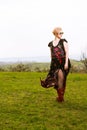 Cool fashionable woman walking in the wind wearing dress and shades. Royalty Free Stock Photo