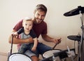 Cool father, baby portrait and drummer musician with music development and child learning. Home, happiness and kid with