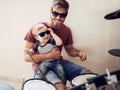 Cool father, baby sunglasses and drummer musician with music development and child learning. Home, happiness and dad