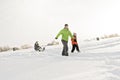 A cool Father drag his boy in sled Royalty Free Stock Photo