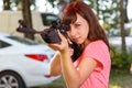 Cool female sniper aiming from telescopic rifle