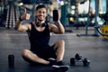 Cool Fitness App. Young Arab Man Posing In Gym With Blank Smartphone