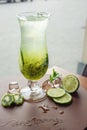 Fruit lemonade in hurricane glass with kiwi and lime Royalty Free Stock Photo