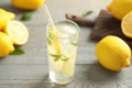 Cool freshly made lemonade and fruits on grey wooden table, closeup Royalty Free Stock Photo