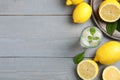 Cool freshly made lemonade and fruits on grey wooden table, flat lay. Space for text