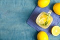 Cool freshly made lemonade and fruits on light blue wooden table, flat lay. Space for text