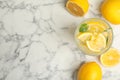 Cool freshly made lemonade and fruits on white marble table, flat lay. Space for text