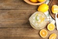 Cool freshly made lemonade and fruits on wooden table, flat lay. Space for text Royalty Free Stock Photo