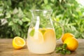 Cool freshly made lemonade in glass pitcher on wooden table Royalty Free Stock Photo