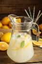 Cool freshly made lemonade in glass pitcher on wooden table Royalty Free Stock Photo