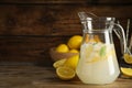 Cool freshly made lemonade in glass pitcher on wooden table. Space for text Royalty Free Stock Photo