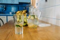 Cool freshly made lemonade in glass pitcher on wooden table. Summer drink Ice cold lemonade in glass and jug Royalty Free Stock Photo