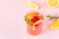 Cool fruit water with paper eco straw on pink background