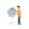 Cool funny cheerful guy choosing clothes , shopping