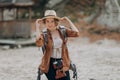 Cool funny girl model with elegant hat, brown jacket, curly hair outdoors overautumn forest background Royalty Free Stock Photo