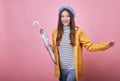 Cool cheerful girl in striped blouse and raincoat is runing with closed umbrella Royalty Free Stock Photo